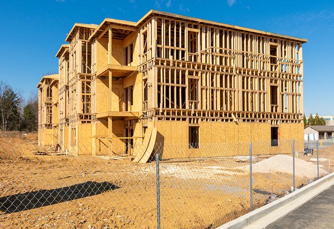 a construction site enclosed by temporary chain link fences, ensuring safety for workers and pedestrians in Neptune Beach